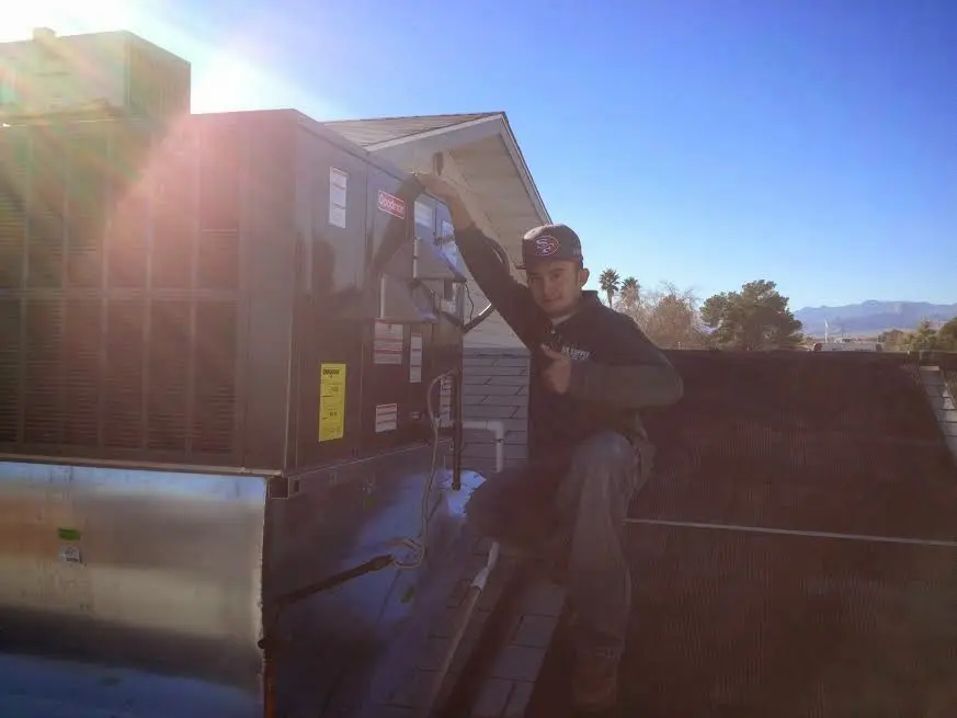 HVAC technician performing HVAC Inspection on a rooftop unit in West Linn